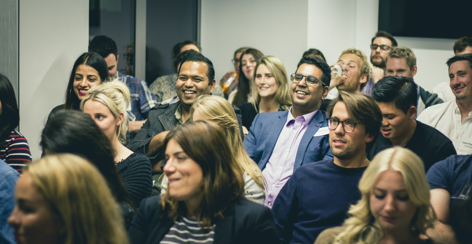 An audience smiling during a company event