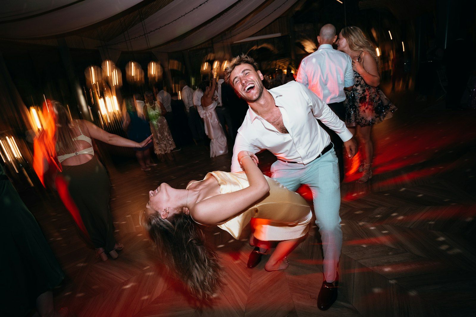 A couple dancing with a dramatic dip on the dance floor