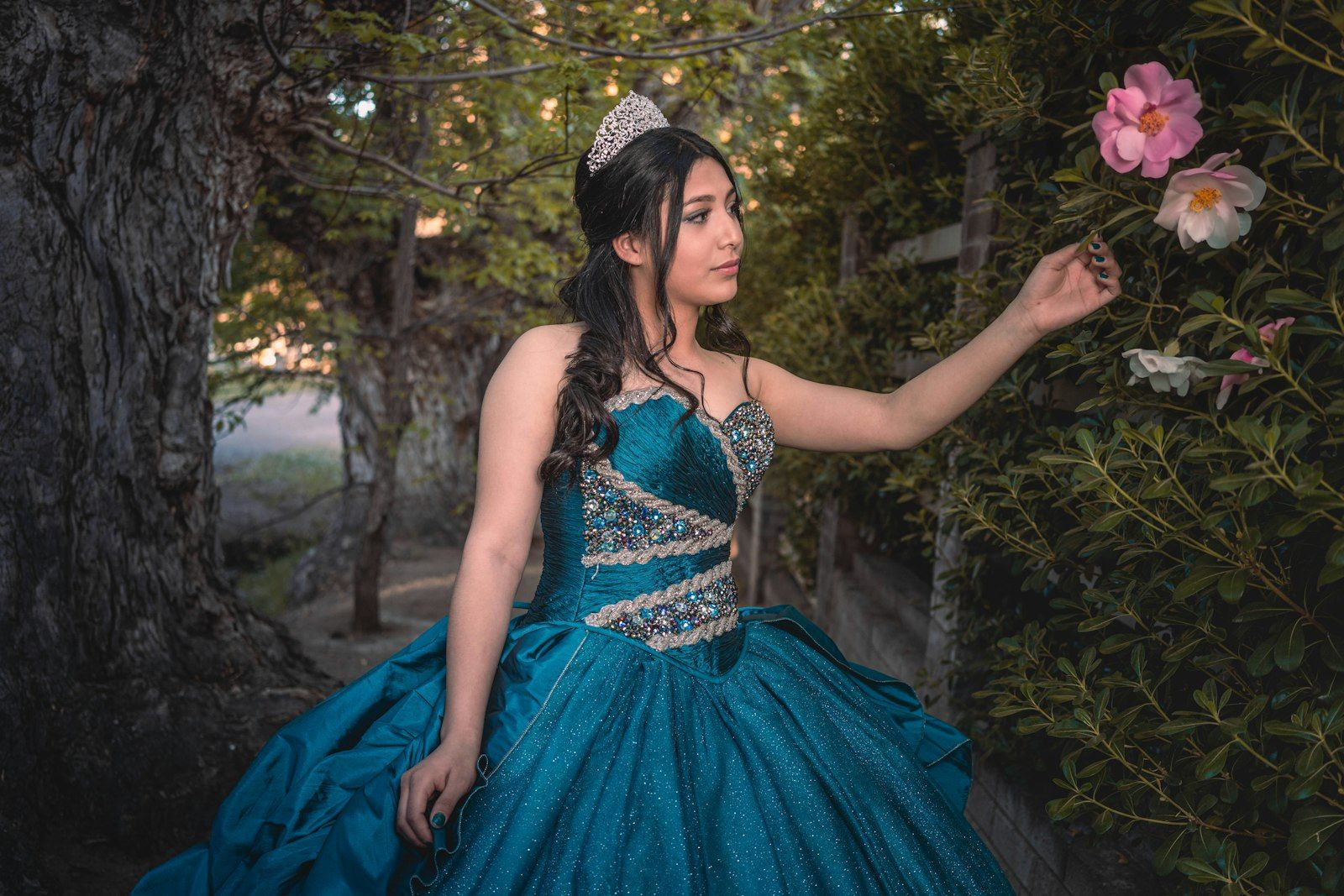 A debutante in a teal ball gown