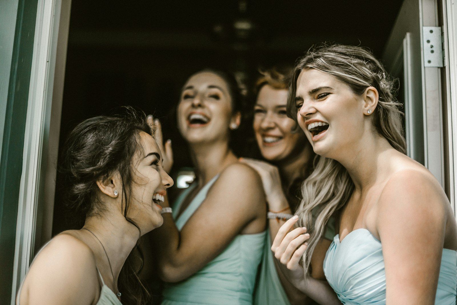 Bridesmaids laughing together at a reception
