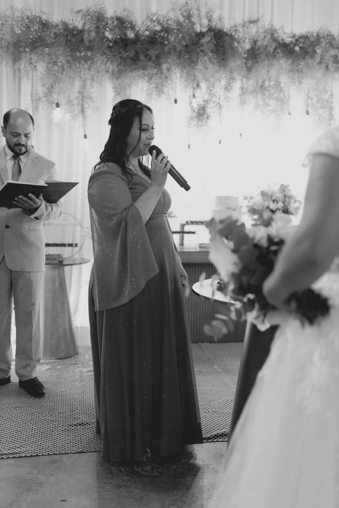 Bianca hosting a wedding ceremony, in black and white